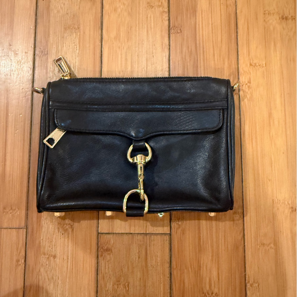 Rebecca Minkoff Black leather studded crossbody bag with gold hardware.